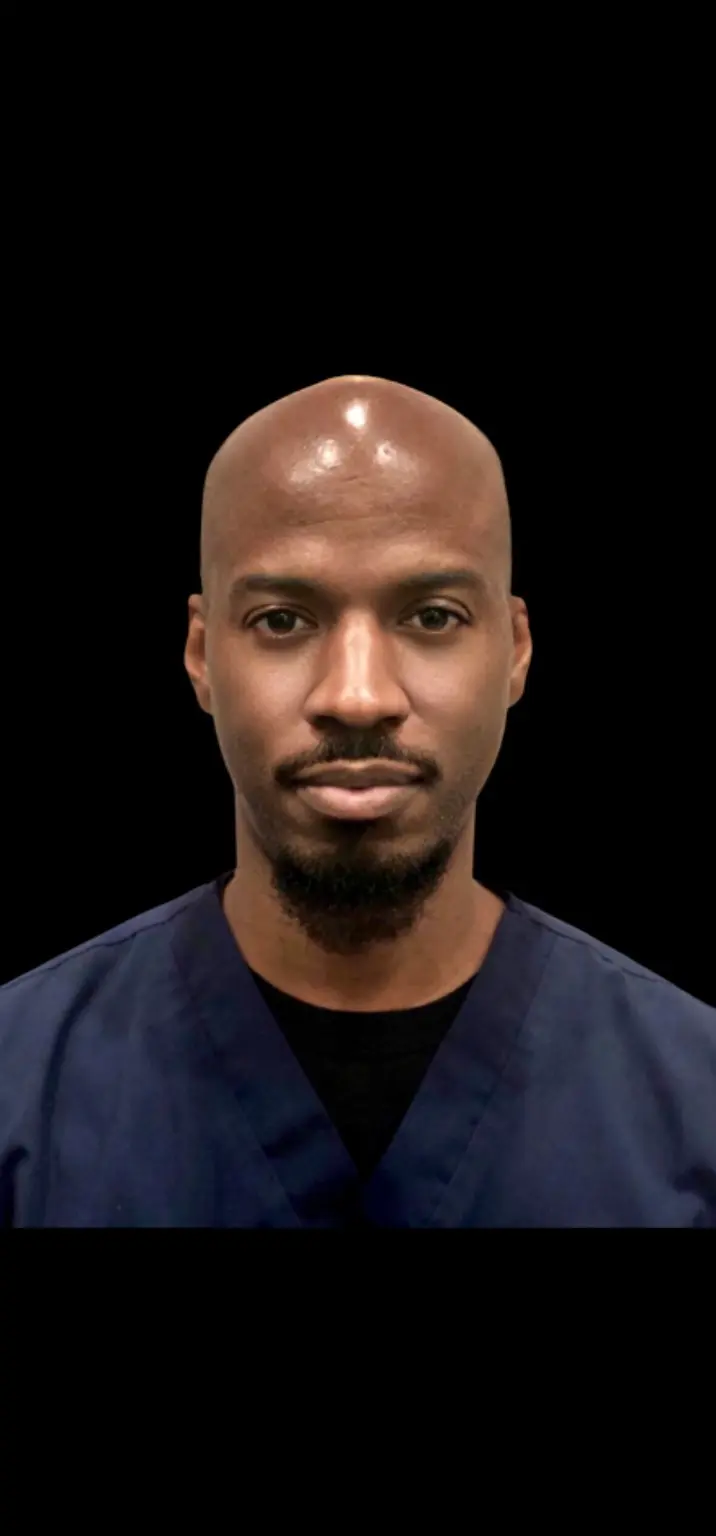 Portrait of Dr. Charles Hooks in navy scrubs
